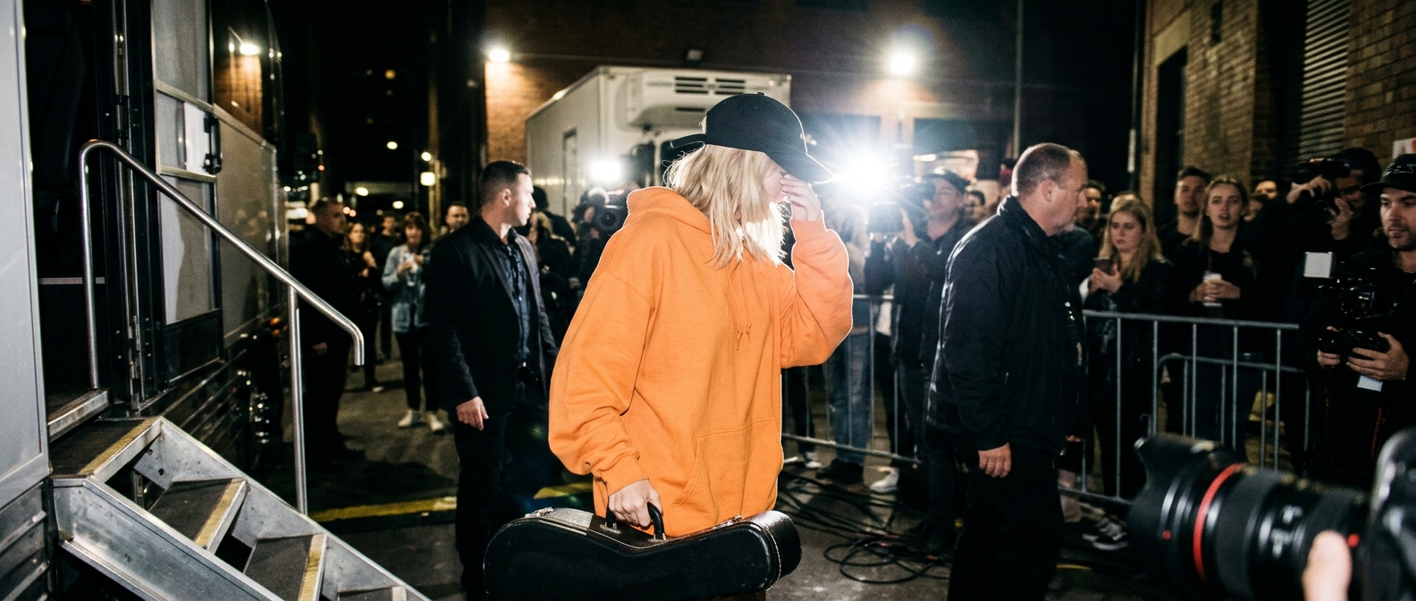 Tones and I turning away backstage amid reports of her NRL Grand Final gig fallout and surprise show.